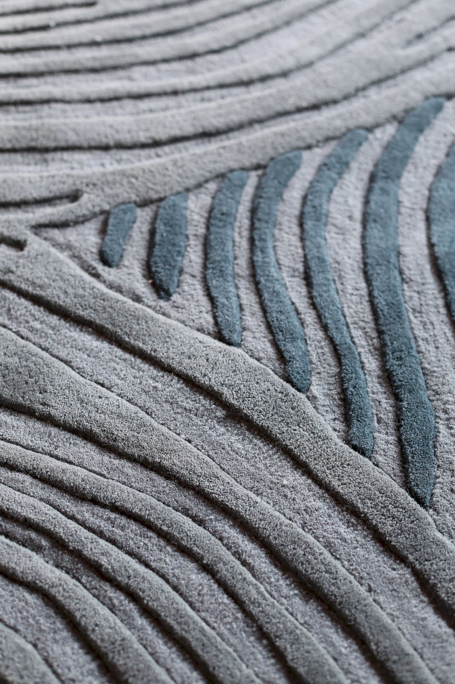 Designer wool rug in teal with sculpted high pile