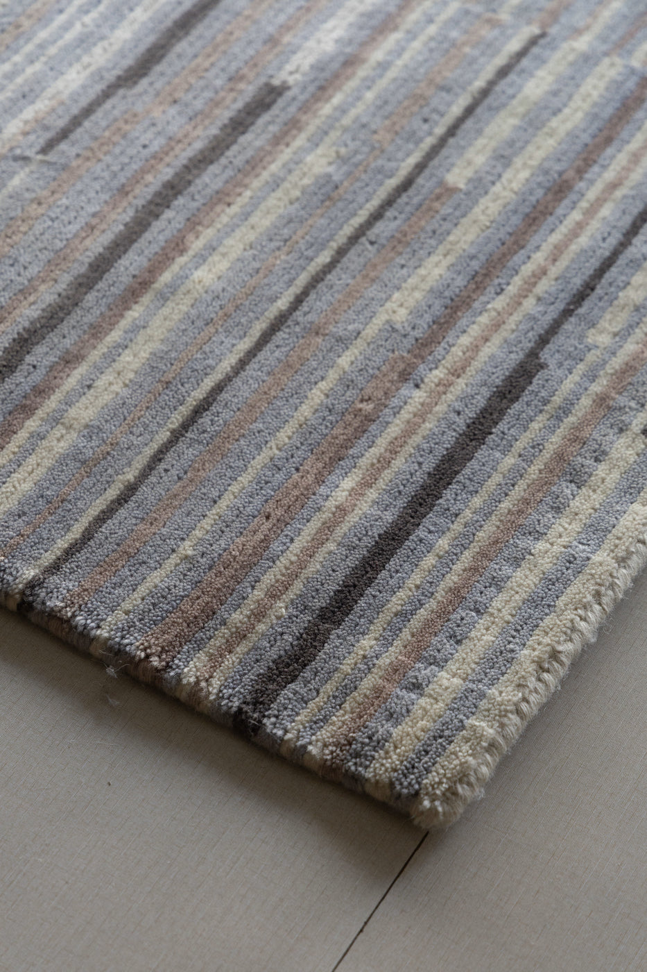Modern neutral area rug made from New Zealand wool with striped design