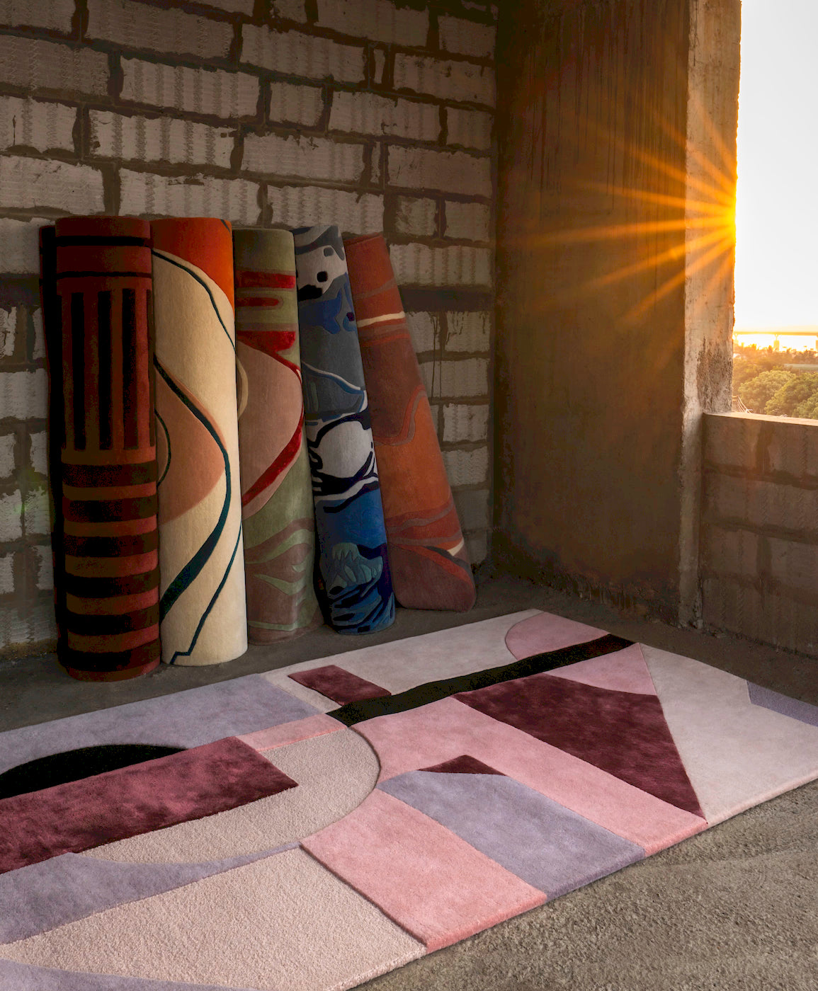 Modern abstract geometric wool rug with pink and burgundy tones