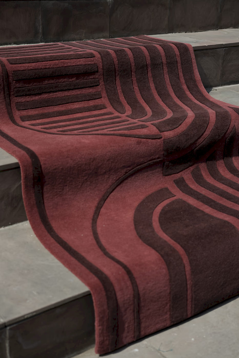 Designer red wool rug with sculpted pile texture