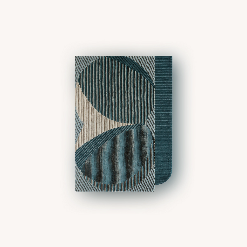 Designer teal rug with sculpted high low pattern